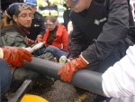 In the tube, two peoples' arms with hands locked together, in the policeman's hands a circular cutter, reason enough to be paranoid. But the police were extremely careful, offering goggles to the activists, constantly checking out with them, taking great care not to do harm. And the young man in this photo, though watching carefully, doesn't look too apprehensive