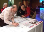 Peter Nowland, Conference Organiser, helping get the reception table ready