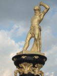 surmounted by a gilded figure