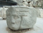 a grumpy face in a carving work area in the quarry