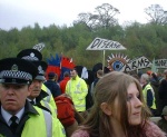 A mingled throng of people locked on or sat down, others supporting, street theatre and the police who were very well behaved aapart from not letting us get off our coaches and sending us up and down the road several times before we could make a break for it