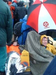 the man in the yellow is locked on to a wheelchair with a cycle D-lock round his neck