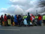 According to Leeds radio as early as 7a.m. while I was driving there, 40 protesters had already been arrested. When I got there, despite the driving rain and fierce wind, some brave souls were blocking a gate to the base, having locked themselves onto a wheelchair.
 
Here, blocking a gate to the base in the freezing wind & rain