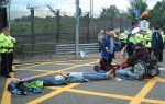 this year the police have a new tactic of surrounding those locked on with a screen whilst they cut them apart - to see how they do that you need to look at Faslane 2004 (on the left of the screen)- it's not so easy to get photos now unless you're very tall!