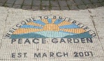 Following the murder of one of their friends in gang warfare, some young people in discussion with their youth worker came up with the idea of a Peace Garden and after a lot of hard work it became reality

here the welcome mosiac
