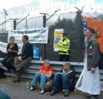 other banners on the fence and some of the protesters
