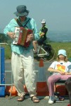 an accordionist outside the base keeping us cheery