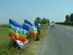 Menwith Hill, Yorkshire U.S. base in all but name (only 1 RAF personnel on the base, where they spy on you and part of US MissileDefence. This was my first demo since breaking my pelvis in January & we made a family outing of it with my daughter Kerris, Jules & their three children, Charis, Orrin and Aelwyn
here, peace flags fluttering over the Yorkshire countryside with a masked demonstrator alongside