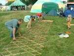 putting up the Home Education yurt - lifting up the side framework