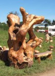 such a wonderful piece of twisted wood among a collection of crafted wooden mushrooms