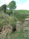 the squeeze through for pedestrians from the stone clam bridge to the footpath to the other end of the ford
