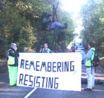 The aim of the day was to disrupt the work of AWE Aldermaston where scientists are, illegally and without approval by Parliament, developing a new generation of warheads for Trident Nuclear missiles. Hundreds of activists descended on Berkshire and used non violent direct action to block the base. Here one is on a tripod blocking the road to the Home Office Gate, a gate which had been blocked for several hours by a previous action. Needless to say any disruption to local traffic which may have been caused is infinitesimally insignificant to the chaos that would be caused by such a warhead exploding whether deliberately or by accident.