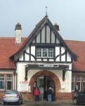 the entrance to the station with it's mock tudor facade in need of repainting